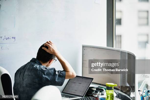 engineer scratching head while looking at calendar on computer monitor in virtual reality lab - 2018 calendar foto e immagini stock
