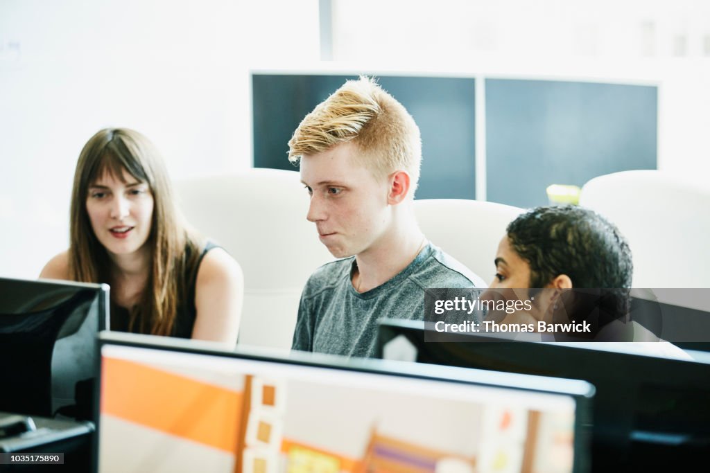 Engineers Trying To Solve Coding Problem While Working Together In ...