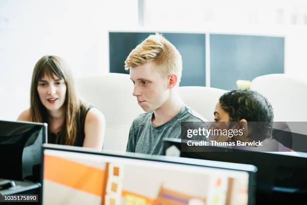 engineers trying to solve coding problem while working together in computer lab - findlater stock pictures, royalty-free photos & images