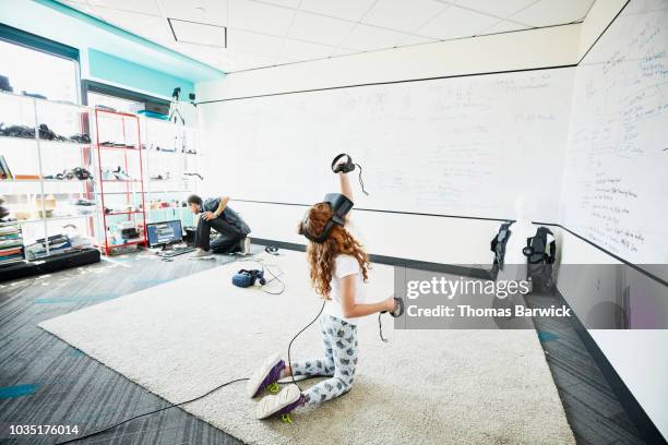 Young girl using virtual reality headset in computer lab