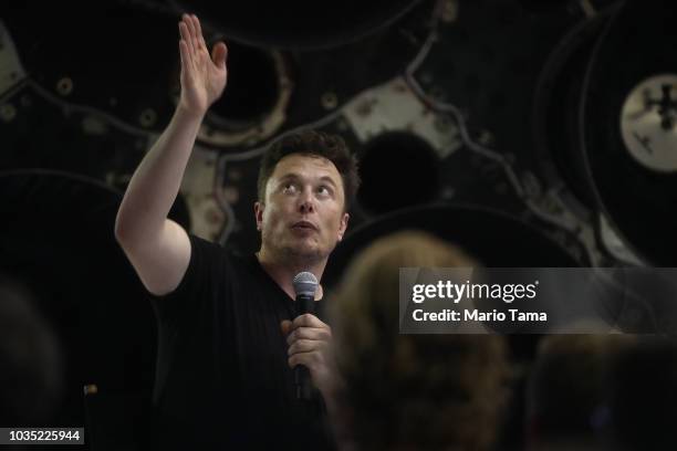 SpaceX CEO Elon Musk speaks in front of rocket components at a press conference where he announced the Japanese billionaire chosen by the company to...