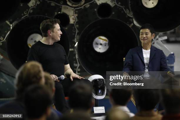 Elon Musk, chief executive officer for Space Exploration Technologies Corp. , left, looks towards Yusaku Maezawa, founder and president of Start...