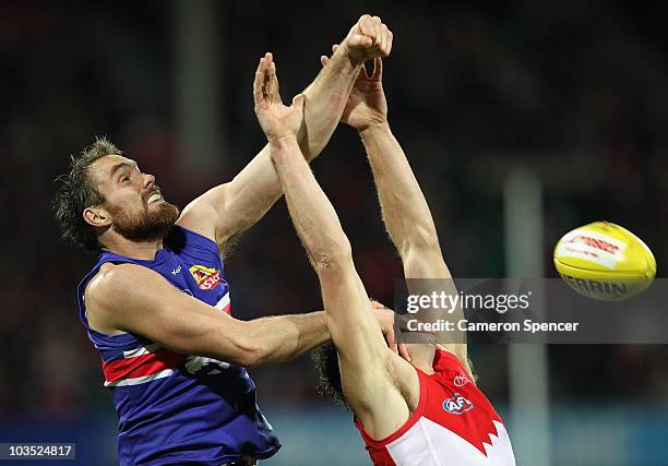 Ben Hudson of the Bulldogs strikes the ball in a mark during the round 21 AFL match between the Sydney Swans and the Western Bulldogs at Sydney...