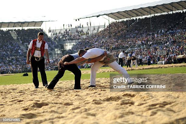 Athletes fight during the opening day of the Federal Alpine Wrestling Festival on August 21, 2010 in Frauenfeld, east of Switzerland. More than 200...