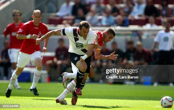 Youssef Mohamad of Koeln tackles Erwin Hoffer of Kaiserslautern during the Bundesliga match between 1. FC Koeln and 1. FC Kaiserslautern at...