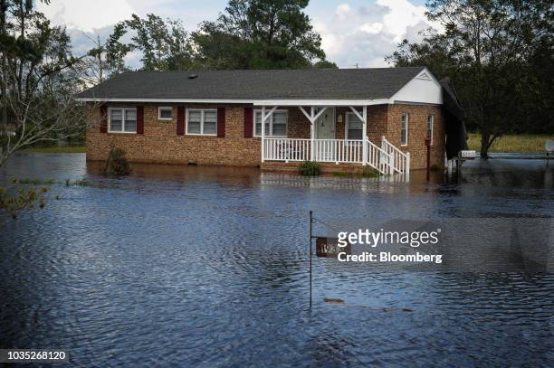 House stands submerged in floodwaters from the River Lumber after Hurricane Florence hit near Lumberton, North Carolina, U.S., on Monday, Sept. 17,...