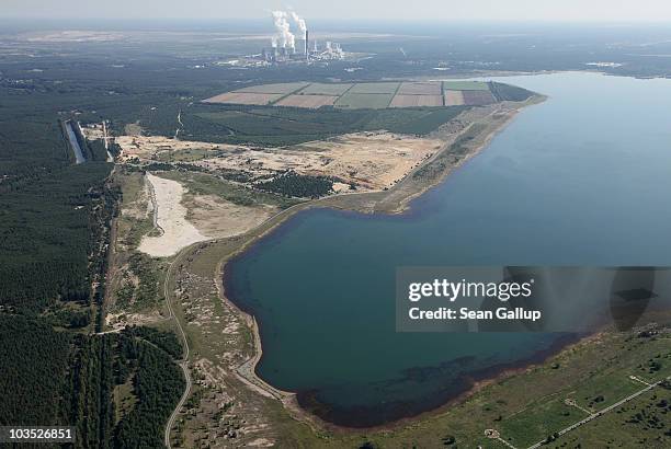 Steam rises from cooling towers at the Boxberg coal-fired power plant next to Baerwalder See lake on August 20, 2010 at Boxberg, Germany. Baerwalder...