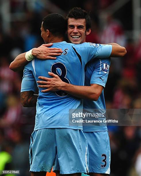 Gareth Bale of Tottenham celebrates with Jermaine Jenas during the Barclays Premier League match between Stoke City and Tottenham Hotspur at the...