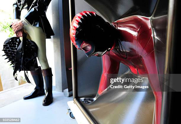 Visitor enjoys a free session in a vacuum cube at the Latexpo 2010 at the Edelfettwerk on August 21, 2010 in Hamburg, Germany. The Latexpo is held...