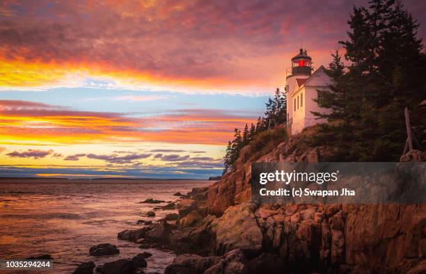 sunset at bass harbor lighthouse - lighthouse sunset stock pictures, royalty-free photos & images