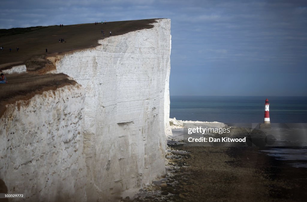 Holiday Makers Enjoy The Seaside Town Of Eastbourne