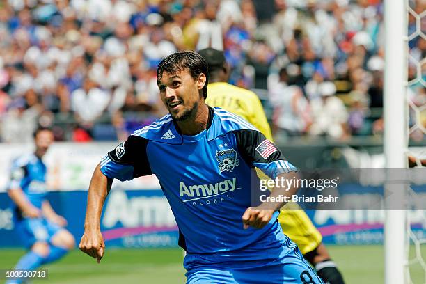 Chris Wondolowski of the San Jose Earthquakes smiles after scoring against goalie Donovan Ricketts of the Los Angeles Galaxy in the first half on...
