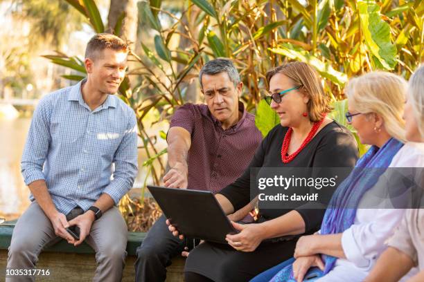 outdoor business meeting in a park - public park worker stock pictures, royalty-free photos & images