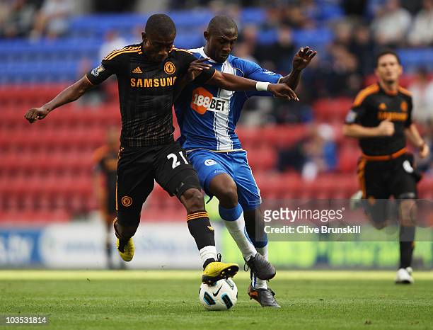 Salomon Kalou of Chelsea battles with Steve Gohouri of Wigan Athletic during the Barclays Premier League match between Wigan Athletic and Chelsea at...