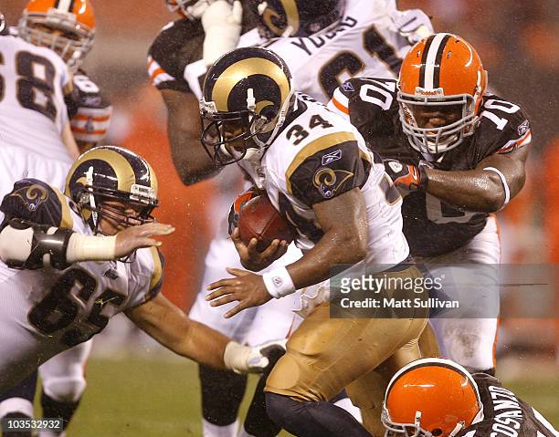 Kenneth Darby of the St. Louis Rams runs by Brian Sanford of the Cleveland Browns at Cleveland Browns Stadium on August 21, 2010 in Cleveland, Ohio.