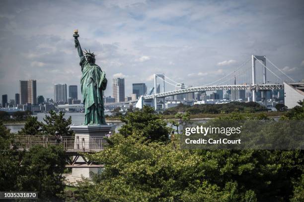 Replica Statue of Liberty and the Rainbow Bridge are pictured in Odaiba Marine Park on September 18, 2018 in Tokyo, Japan. Odaiba Marine Park is one...