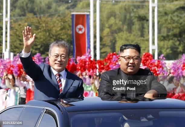 South Korean President Moon Jae-in and North Korean leader Kim Jong-un ride in a car parade on September 18, 2018 in Pyongyang, North Korea. Kim and...