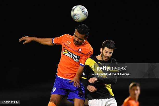 Jean Carlos Solorzano of Lions FC and Andrew Cartanos of Heidelberg United compete for the ball during the NPL Semi Final match between Lions FC and...