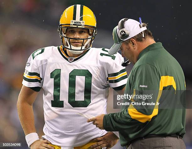 Quarterback Matt Flynn of the Green Bay Packers talks with head coach Mike McCarthy during the preseason game against the Seattle Seahawks at Qwest...