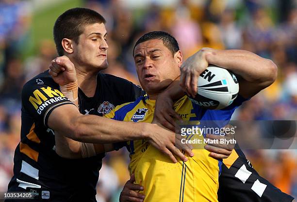 Timana Tahu of the Eels is tackled during the round 24 NRL match between the Parramatta Eels and the Wests Tigers at Parramatta Stadium on August 22,...