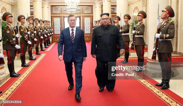 North Korean leader Kim Jong Un walks with South Korean President Moon Jae-in before their summit at the Workers' Party of Korea headquarters on...