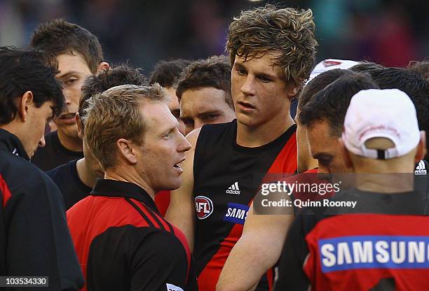 Matthew Knights the coach of the Bombers talks to his players during the round 21 AFL match between the Essendon Bombers and the Brisbane Lions at...