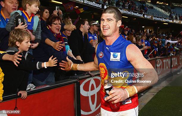 Jonathan Brown of the Lions high fives the crowd after playing his 200th game during the round 21 AFL match between the Essendon Bombers and the...