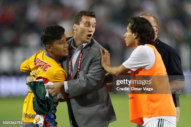 Fan of Mexico goes down to the field to take picture with Diego Lainez during an international friendly match between Mexico and United States at...