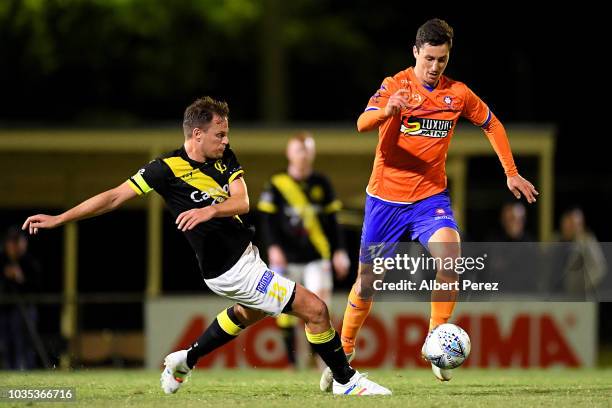 Marek Madle of Lions FC evades the tackle from Luke Byles of Heidelberg United during the NPL Semi Final match between Lions FC and Heidelberg United...