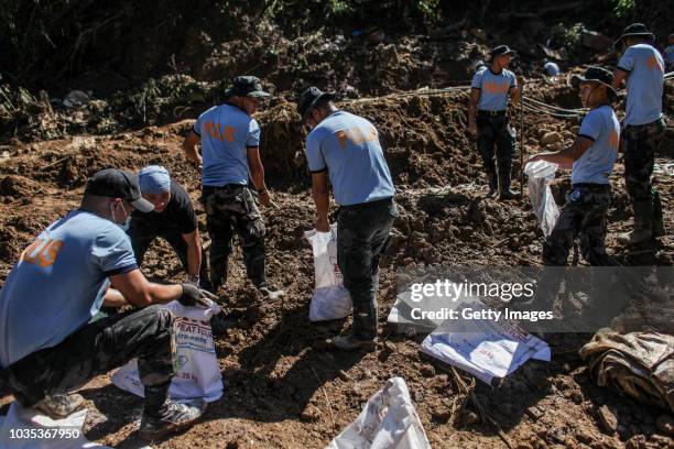 Filipino rescuers dig at the site where dozens of people were believed to have been buried by a landslide on September 18, 2018 in in Itogon, Benguet...