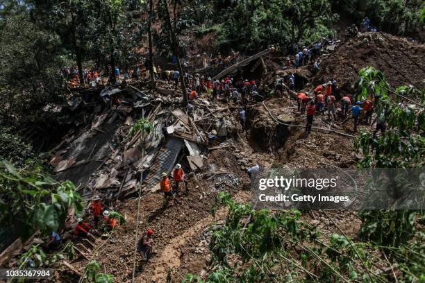 Filipino rescuers dig at the site where dozens of people were believed to have been buried by a landslide on September 18, 2018 in in Itogon, Benguet...