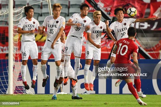 Kashima Antlers' Shuto Yamamoto, Jung Seung-Hyun, Tomoya Inukai, Yuma Suzuki and Kento Misao defend a freekick taken by Tianjin Quanjian's Alexandre...