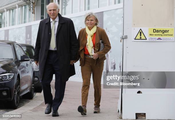 Vince Cable, leader of the U.K.'s Liberal Democrat Party, left, arrives with his wife, Rachel Smith, ahead of delivering his keynote speech at the...