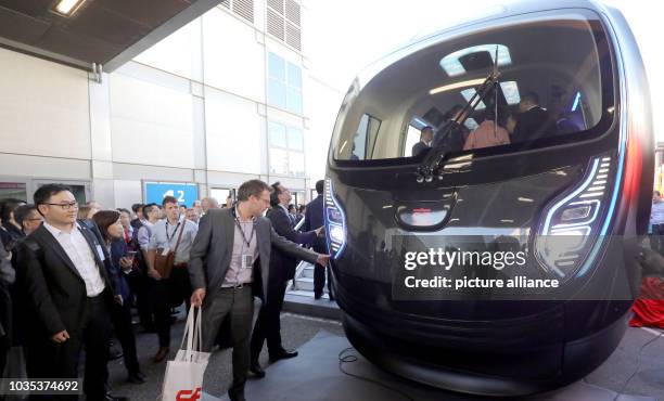 September 2018, Berlin: At the Innotrans railway trade fair, people are standing in front of a Chinese metro train of the company CRRC in lightweight...