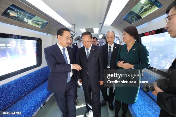 September 2018, Berlin: A Chinese delegation walks through a Chinese subway train of the company CRRC at the railway fair Innotrans. The train will...