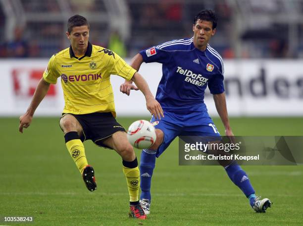 Michael Ballack of Leverkusen challenges Robert Lewandowski of Dortmund during the Bundesliga match between Borussia Dortmund and Bayer 04 Leverkusen...