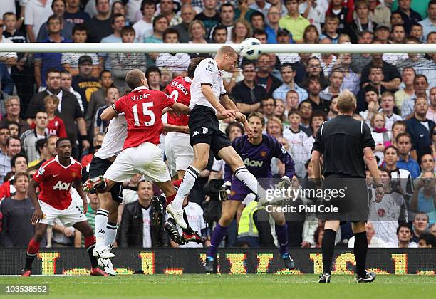 Brede Hangeland of Fulham scores their second goal with a header during the Barclays Premier League match between Fulham and Manchester United at...