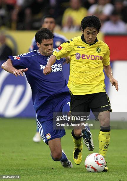 Michael Ballack of Leverkusen and Shinji Kagawa of Dortmund battle for the ball during the Bundesliga match between Borussia Dortmund and Bayer...