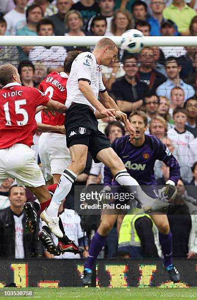 Brede Hangeland of Fulham scores their second goal with a header during the Barclays Premier League match between Fulham and Manchester United at...