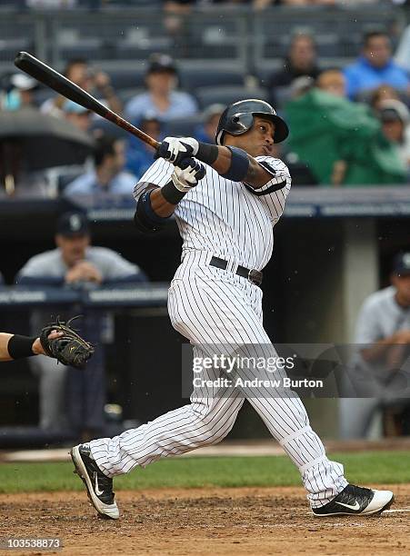 Robinson Cano of the New York Yankees watches his grand slam home run against the Seattle Mariners on August 22, 2010 at Yankee Stadium in the Bronx...