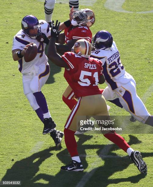 Brett Favre of the Minnesota Vikings is pressured by Patrick Willis and Takeo Spikes of the San Francisco 49ers during an NFL pre-season game at...
