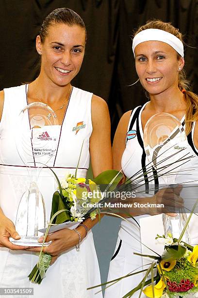 Flavia Pennetta of Italy and Gisela Dulko of Argentina pose for photographers after winning the doubles championship during the Rogers Cup at the...