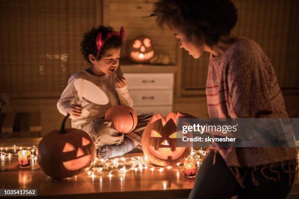 african american mother and her son preparing for halloween party at home. - fall decoration stock pictures, royalty-free photos & images