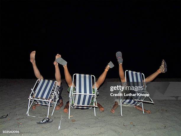 crazy teenage beach boys fooling around - silly fun stock-fotos und bilder