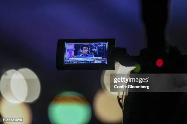 Nitin Gadkari, India's minister of shipping, road transport and highway water resources, is displayed on a television camera viewfinder during the...
