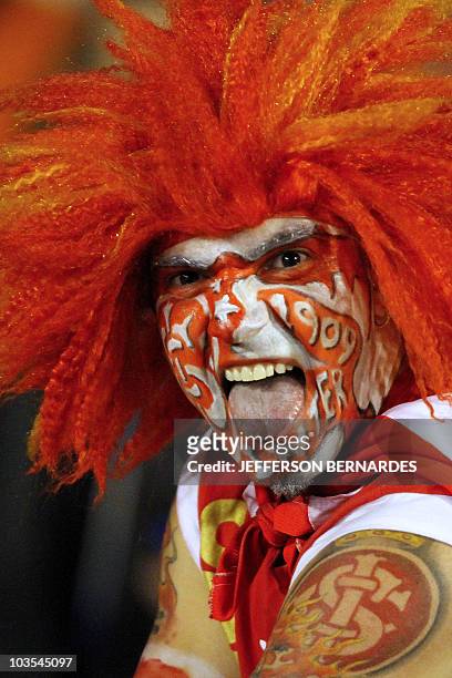 Supporter of Brazilian football team Internacional cheers before the start of the Libertadores Cup final match against Mexico's Chivas on August 18,...