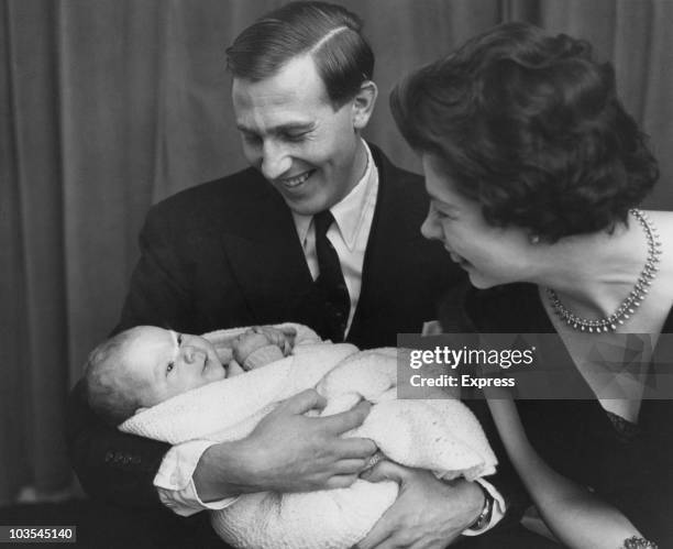 Athlete Roger Bannister and his wife with their two-month-old son Clive pictured prior to Cive's christening, Great Britain, 3 January 1959.