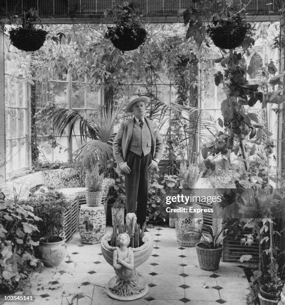 Cecil Beaton , fashion and portrait photographer, pictured in conservatory of his London home, Great Britain, circa 1960.