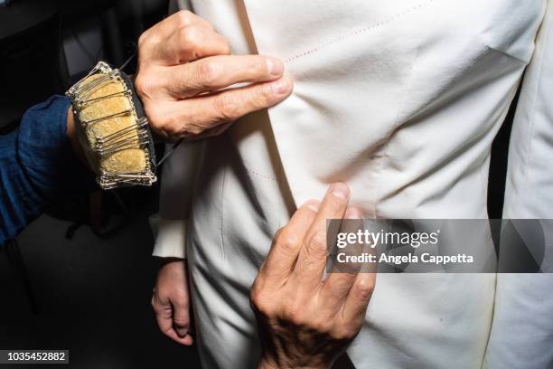 fit model in fitting of tailored jackets before fashion week - pressure photos et images de collection