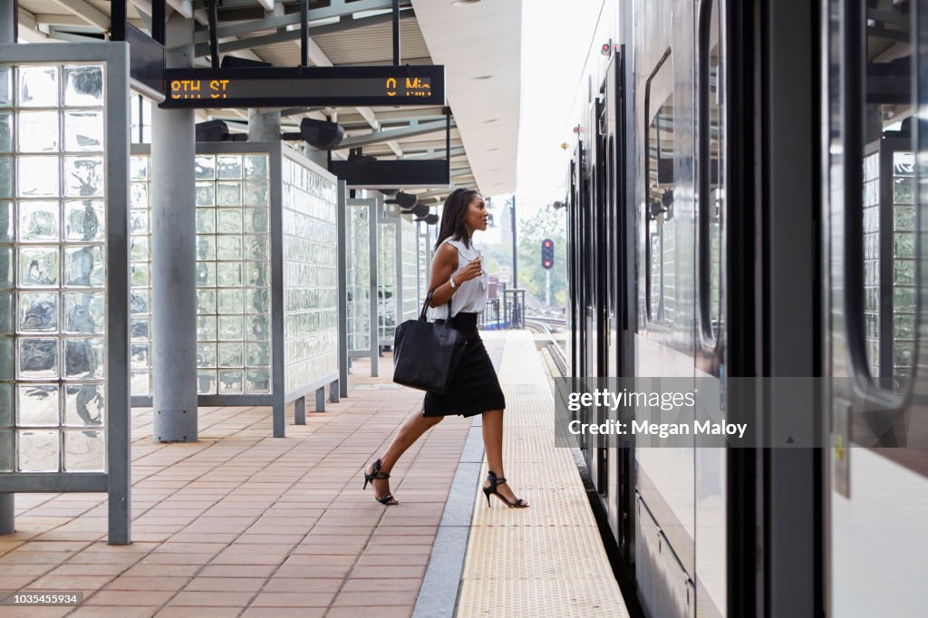 Businesswoman boarding train